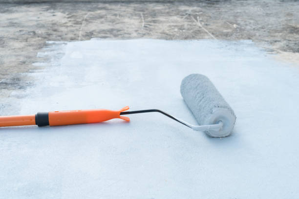 istock Rolling paint brush that is placed on a gray area. 1131545647