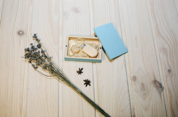 istock Decorative wooden box for presents, memory sticks or money. Ecological friendly package for wrapping. Lavender, anise-tree stars and cinnamon lying nearby. Rustic vintage style. 1131546045