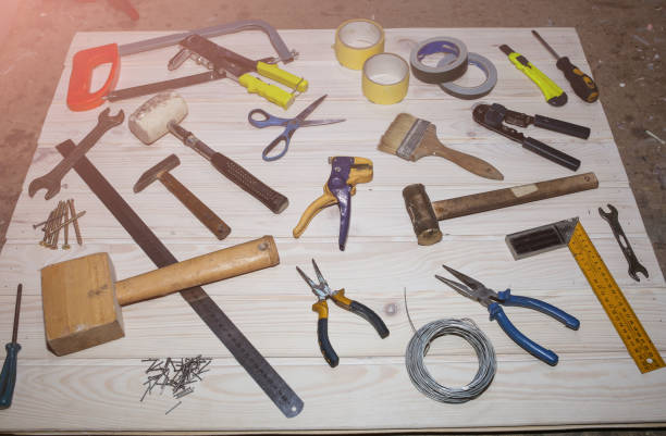 istock Working instruments lying on the wooden board. Scissors, scotch tape, pliers, brushes are used for maintenance repairing works. 1131546080