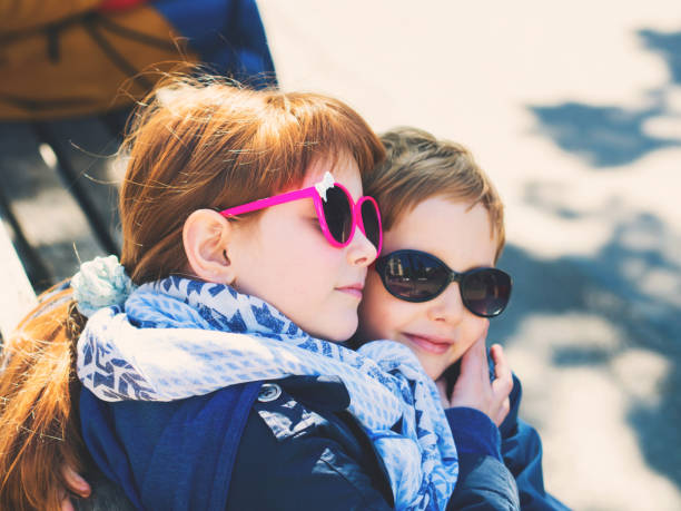 istock Two cute kids, siblings hugging outdoors 1131547486