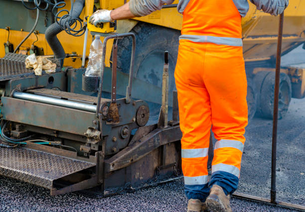 istock Workers regulate tracked paver laying asphalt heated to temperatures above 160 ° pavement on a runway 1131548177