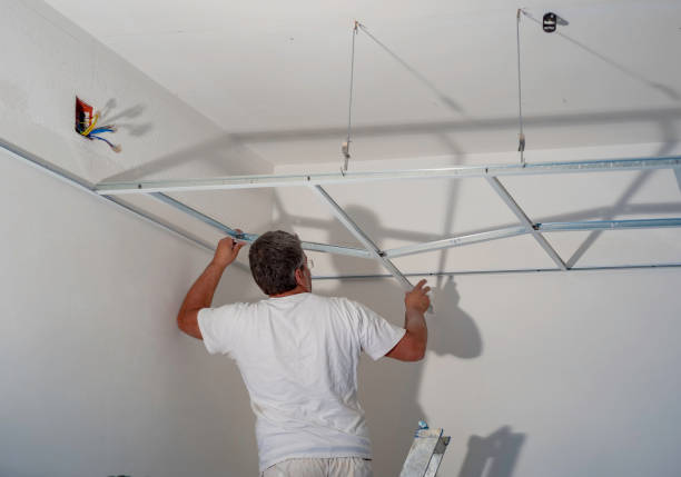 istock Construction worker assemble a suspended ceiling with drywall and fixing the drywall to the ceiling metal frame with screwdriver. 1131548360