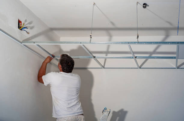 istock Construction worker assemble a suspended ceiling with drywall and fixing the drywall to the ceiling metal frame with screwdriver. 1131548417