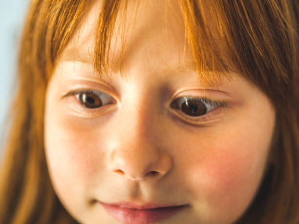 istock Cute redhead little girl. Funny expression 1131549562