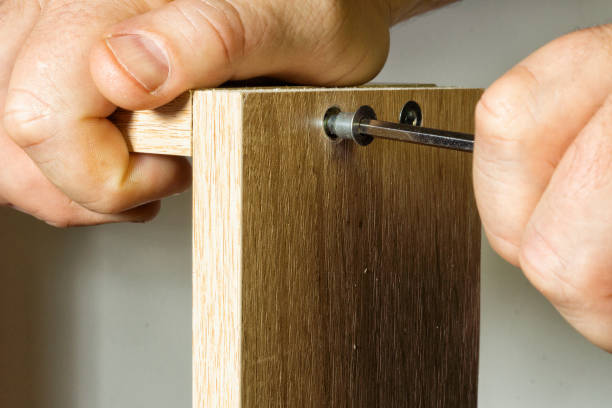 istock Installation in the socket with the help of a threaded furniture fastener tool 1131550156