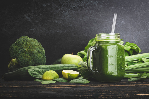 Detox diet concept: green vegetables on rustic table