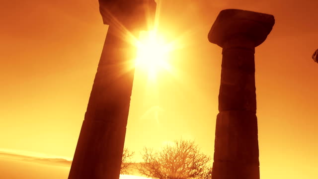 Antique pillar on sky background at sunset