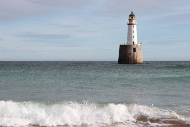 istock White lighthouse on granite platform in sea with copy space 1131559466