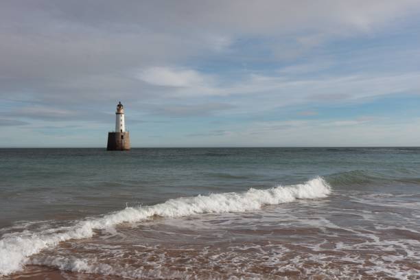 istock White lighthouse on granite platform in sea with copy space 1131559493