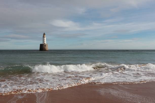 istock White lighthouse on granite platform in sea with copy space 1131559494