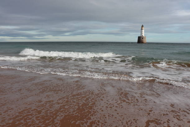 istock White lighthouse on granite platform in sea with copy space 1131559517