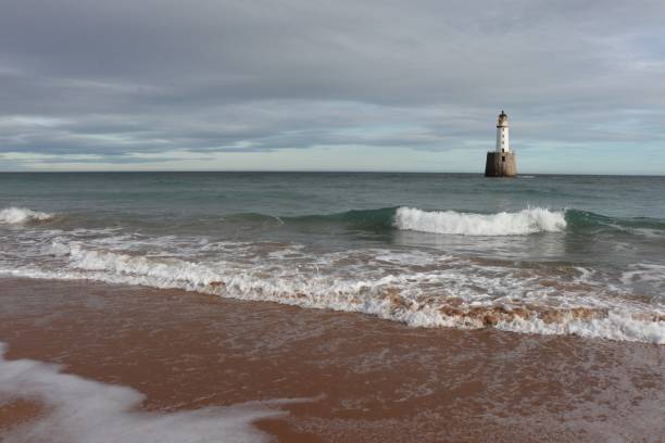 istock White lighthouse on granite platform in sea with copy space 1131559523