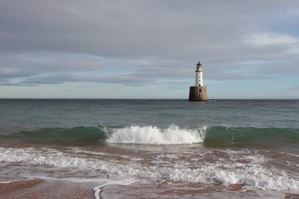 istock White lighthouse on granite platform in sea with copy space 1131559537