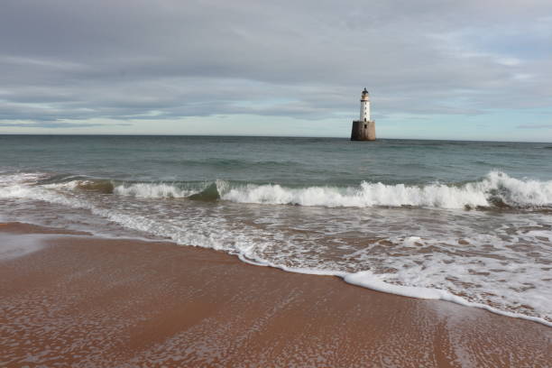 istock White lighthouse on granite platform in sea with copy space 1131559556