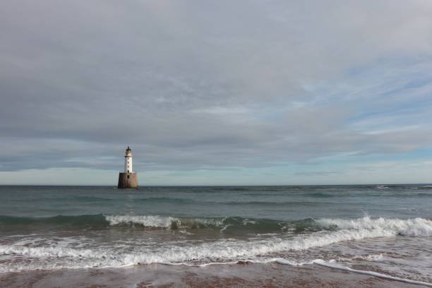 istock White lighthouse on granite platform in sea with copy space 1131559572