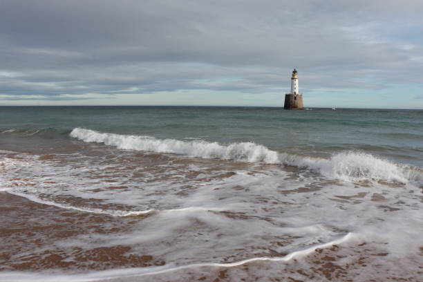 istock White lighthouse on granite platform in sea with copy space 1131559580