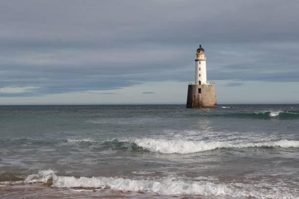 istock White lighthouse on granite platform in sea with copy space 1131559591