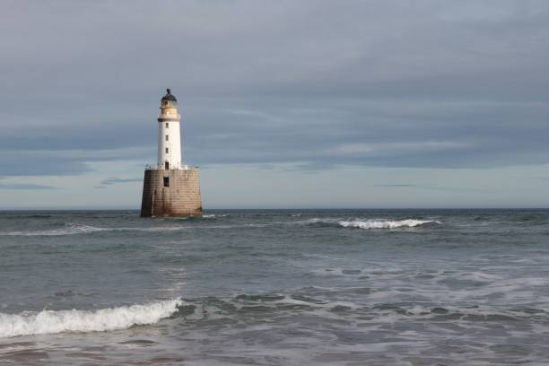istock White lighthouse on granite platform in sea with copy space 1131559651