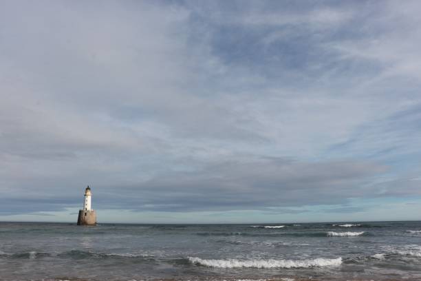 istock White lighthouse on granite platform in sea with copy space 1131559660
