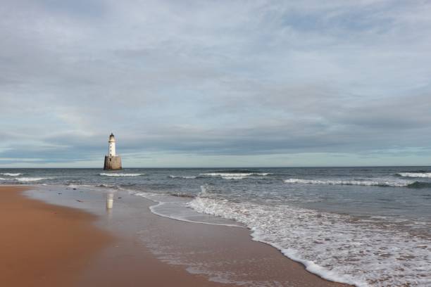 istock White lighthouse on granite platform in sea with copy space 1131559667
