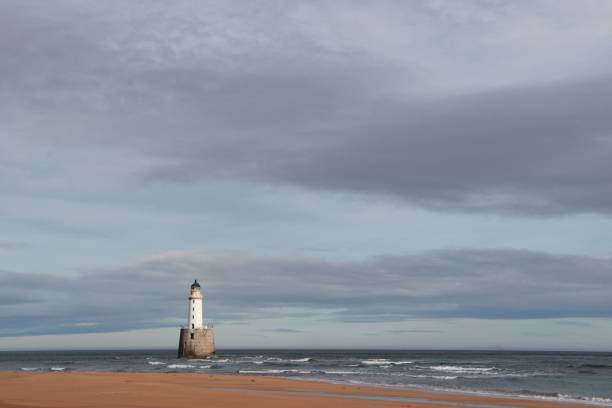 istock White lighthouse on granite platform in sea with copy space 1131559668