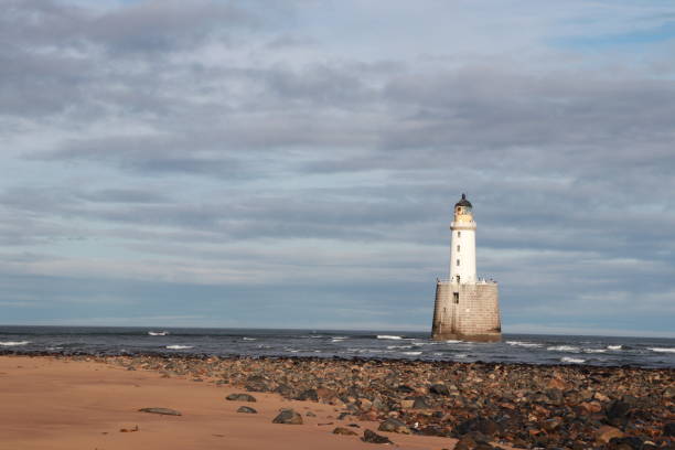 istock White lighthouse on granite platform in sea with copy space 1131559730