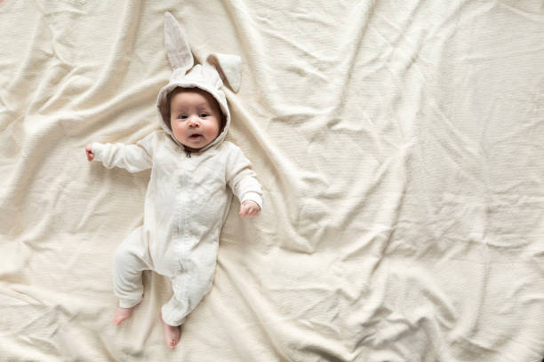 istock Having fun on Easter day. Baby boy wearing bunny costume with ears smiling. 1131560785