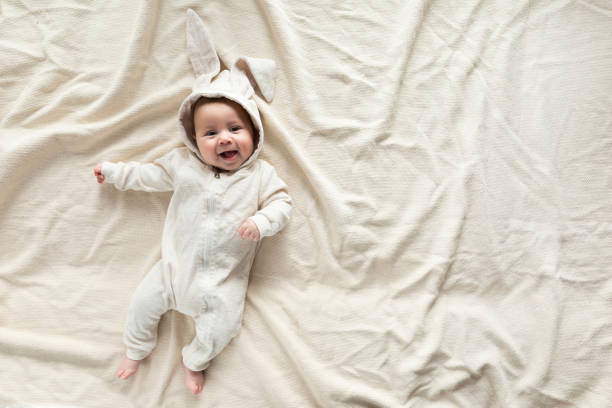 istock Having fun on Easter day. Baby boy wearing bunny costume with ears smiling. 1131560788