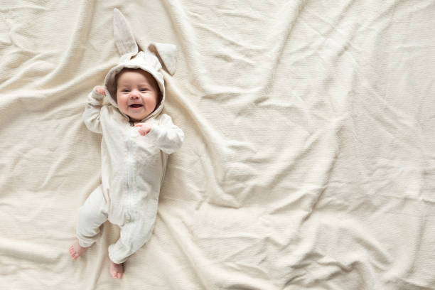 istock Having fun on Easter day. Baby boy wearing bunny costume with ears smiling. 1131560794