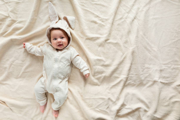 istock Having fun on Easter day. Baby boy wearing bunny costume with ears smiling. 1131560811