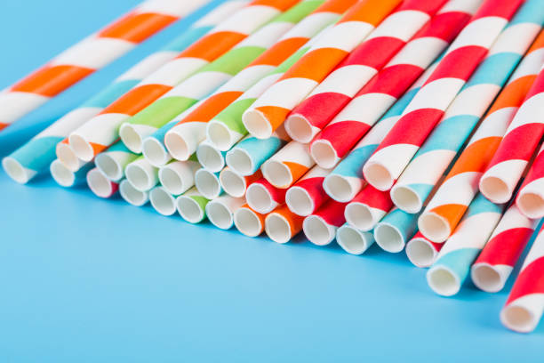 istock Colorful stripped paper straws on blue background 1131561858