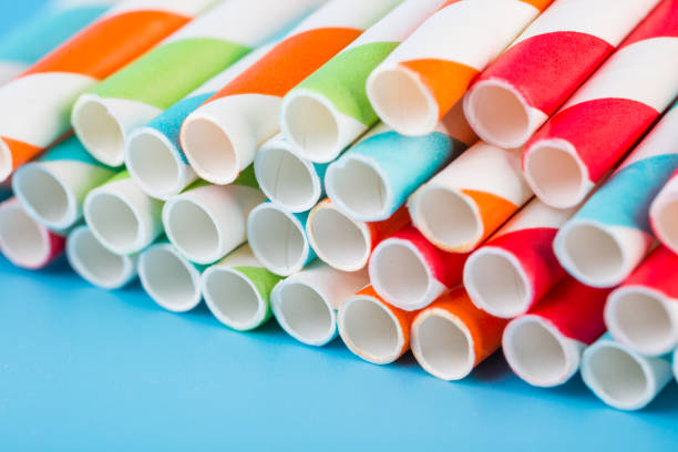 istock Colorful stripped paper straws on blue background 1131561862