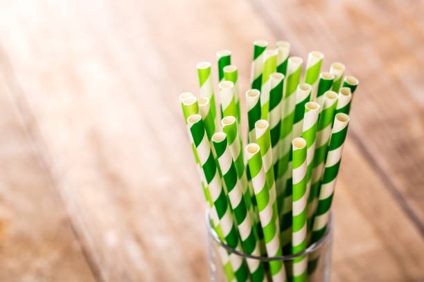 Stripped paper drink straws in glass.