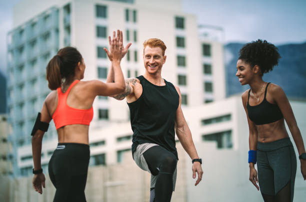 istock Fitness people relaxing after workout standing on rooftop 1131564565