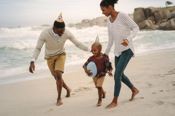 istock Family running along the beach 1131564980