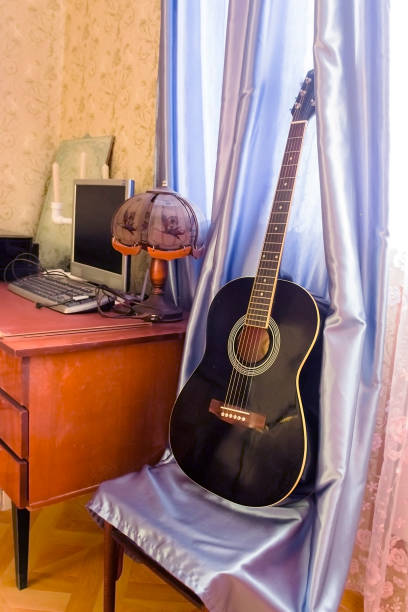 istock guitar that stands on a chair next to the table 1131565810