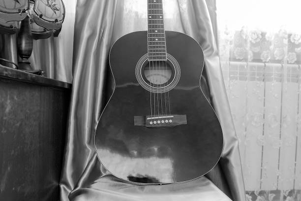 istock guitar that stands on a chair next to the table 1131566218