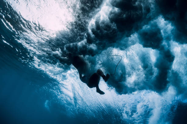 istock Surfer girl dive underwater. Wave washing surfer 1131567163