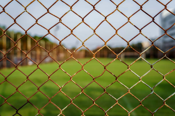 istock Rust steel net with blur football field. 1131572534