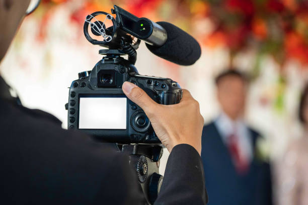 Female Videographer in backside are shooing and recording video in Wedding Event. Female Videographer in backside are shooing and recording video in Wedding Event. microphone photos stock pictures, royalty-free photos & images