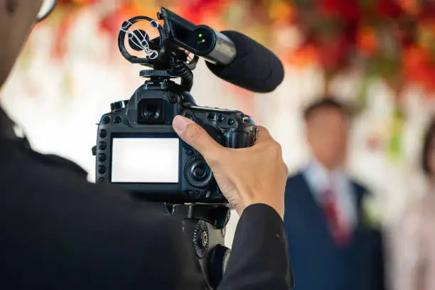Female Videographer in backside are shooing and recording video in Wedding Event.