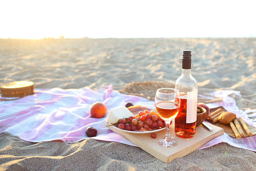 Picnic outdoor with rose wine fruits meat and cheese