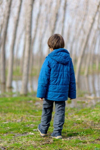 istock Young boy on woodland path 1131577047