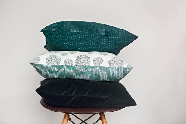 Green pillows on the chair on light background