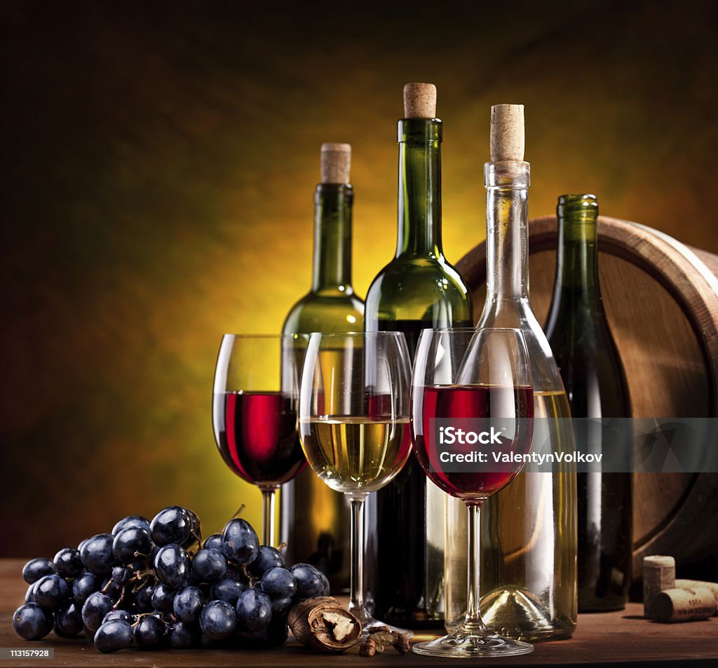 Still life with wine bottles. Still life with wine bottles, glasses and oak barrels. Alcohol - Drink Stock Photo