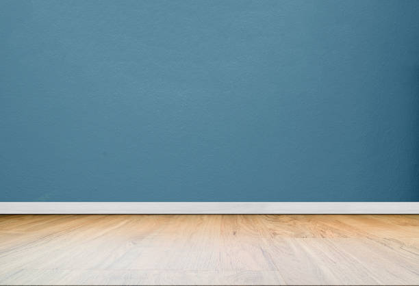 istock Blue concrete wall in empty room with wooden floor. 1131580932