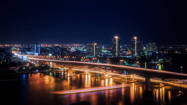 istock Urban Night Scene Skyline Bright Lights Bridge River Generic City Landscape 1131581060