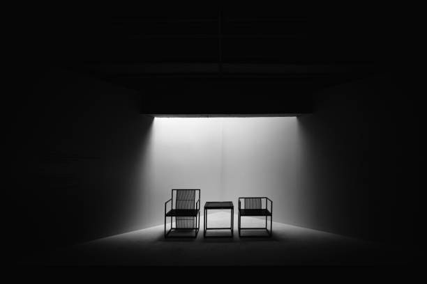 istock Two Black and White Dramatic Chairs Seating Meeting Decision Important Together Small Table Spotlight Empty Nobody 1131581080