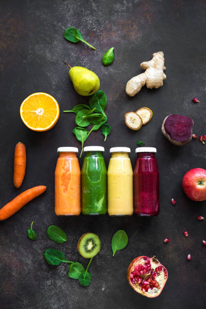 frascos e ingredientes coloridos do smoothie - healthy eating multi colored orange above - fotografias e filmes do acervo