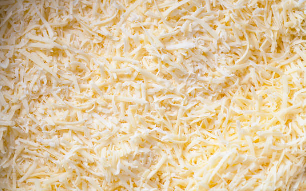 Grated cheddar cheese texture for cooking, top view stock photo